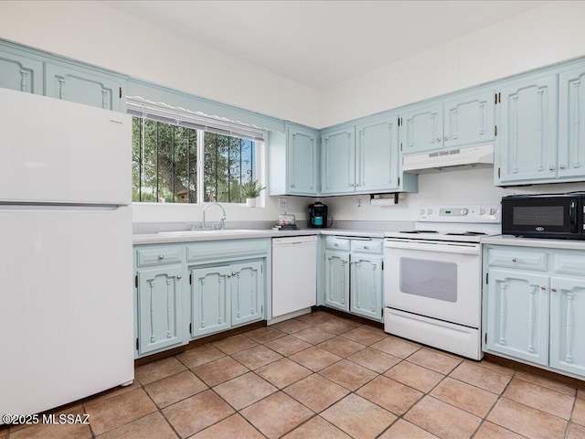 kitchen with white appliances, light tile patterned floors, and sink