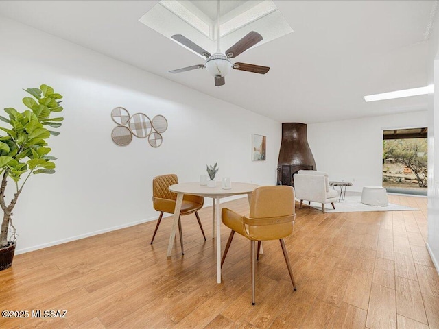 dining room with ceiling fan and light hardwood / wood-style flooring