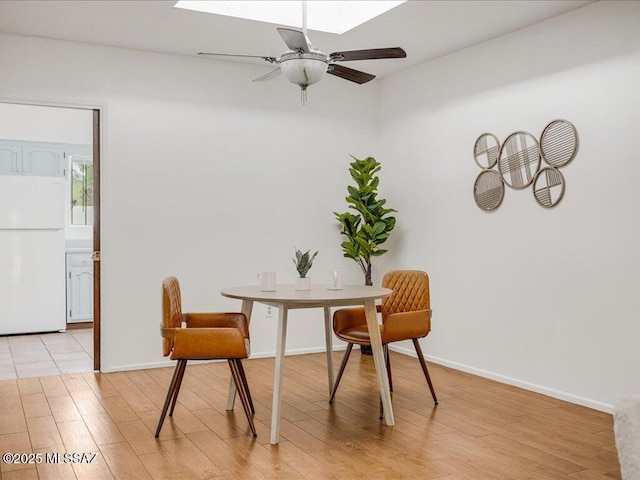 dining area with ceiling fan and light hardwood / wood-style floors