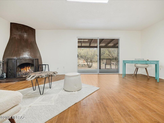 living area featuring hardwood / wood-style floors and a fireplace