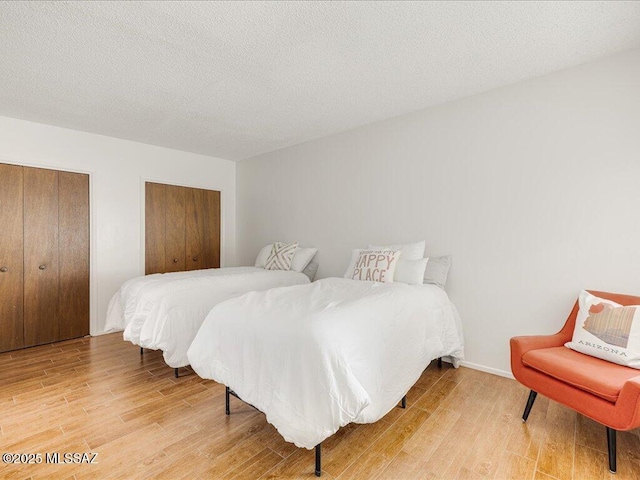 bedroom featuring a textured ceiling and hardwood / wood-style floors