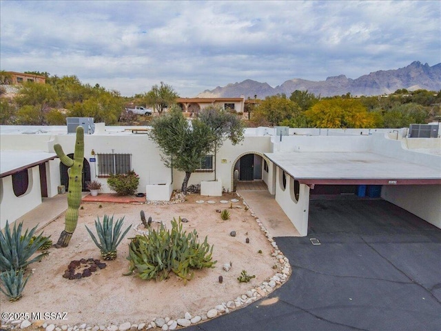 view of front facade featuring a carport and a mountain view