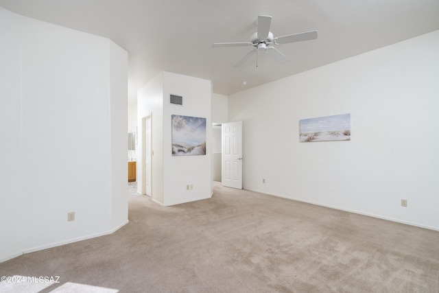 unfurnished room featuring light carpet and ceiling fan