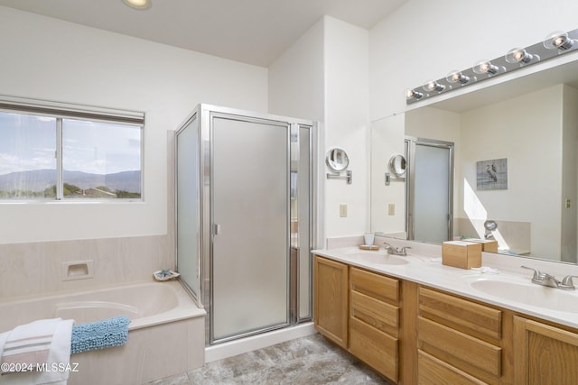 bathroom with vanity and shower with separate bathtub