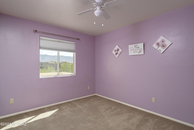 carpeted empty room with ceiling fan