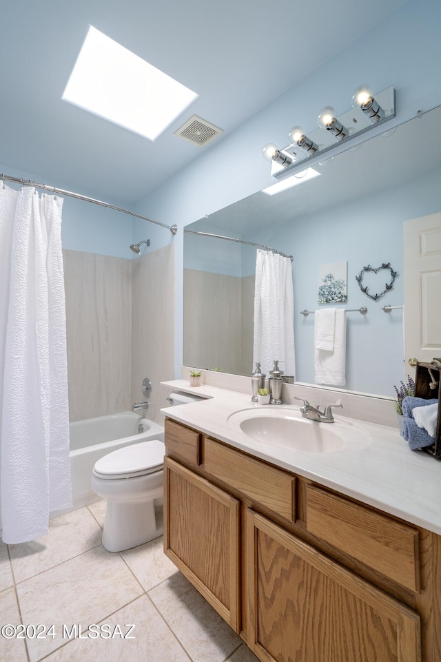 full bathroom with a skylight, shower / bathtub combination with curtain, tile patterned flooring, toilet, and vanity