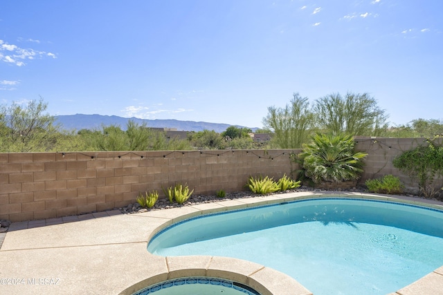 view of swimming pool featuring a mountain view