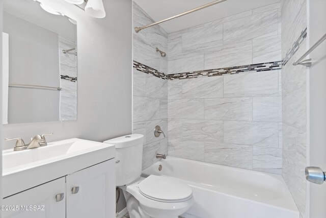 full bathroom with vanity, toilet, and tiled shower / bath combo