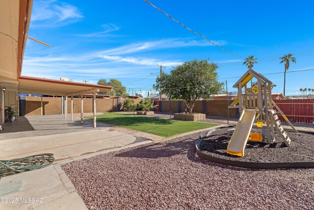 view of yard featuring a playground and a patio area