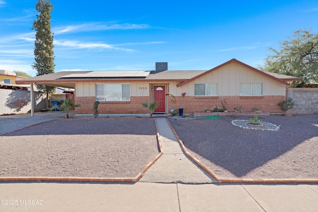 ranch-style home featuring solar panels