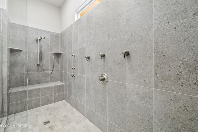 bathroom with tiled shower