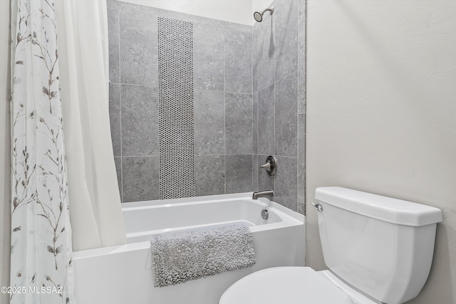 bathroom with shower / bath combo and toilet