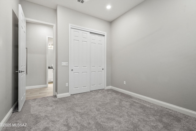 unfurnished bedroom with a closet and carpet