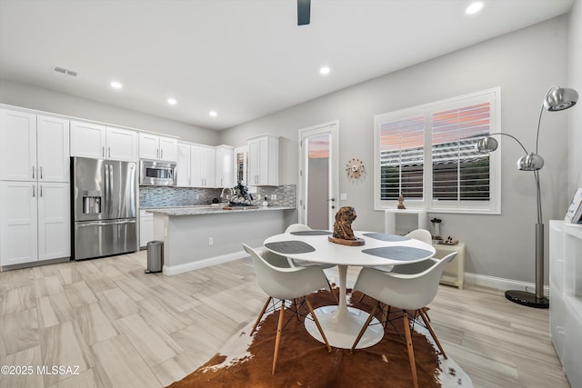 dining space with light hardwood / wood-style flooring