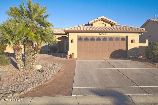 mediterranean / spanish-style home with a garage