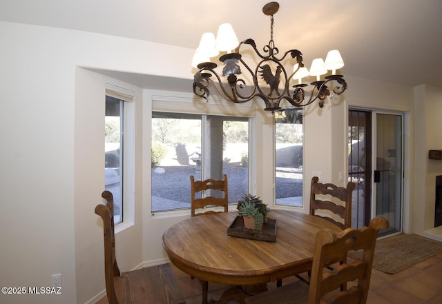 dining space featuring hardwood / wood-style floors and a chandelier