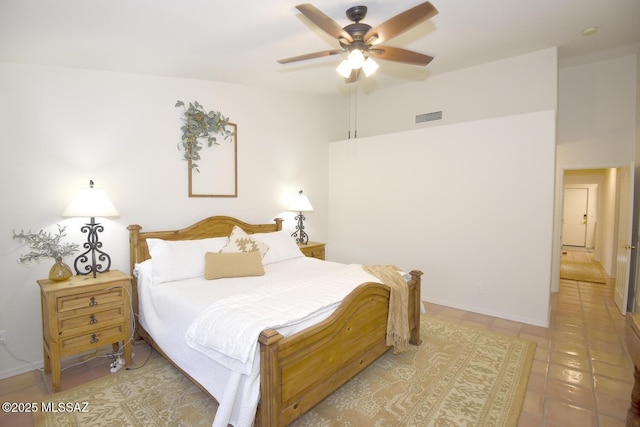 tiled bedroom featuring ceiling fan