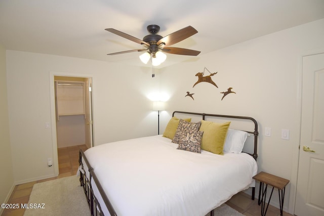 bedroom featuring a closet, a spacious closet, and ceiling fan