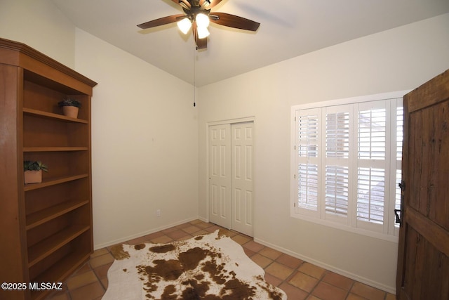 interior space featuring ceiling fan and light tile patterned floors