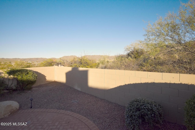 view of yard with a mountain view and a patio