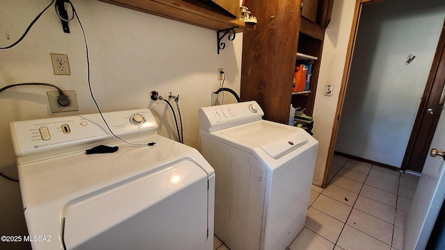 washroom with independent washer and dryer and light tile patterned floors