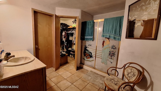 bathroom featuring tile patterned flooring and vanity