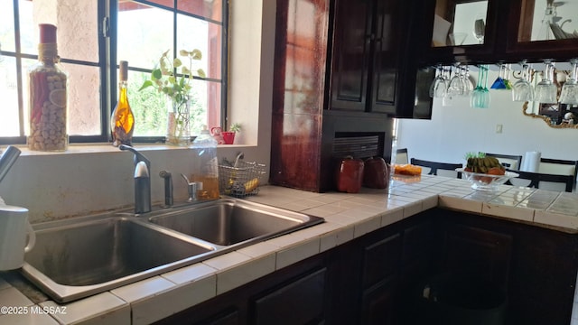 kitchen with tile counters and sink