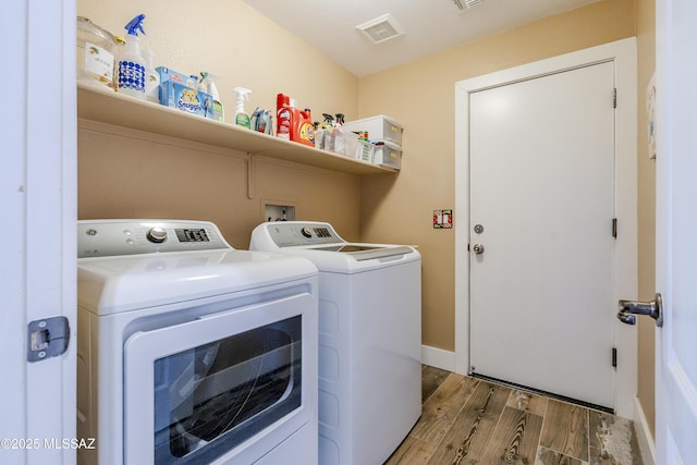 clothes washing area with separate washer and dryer