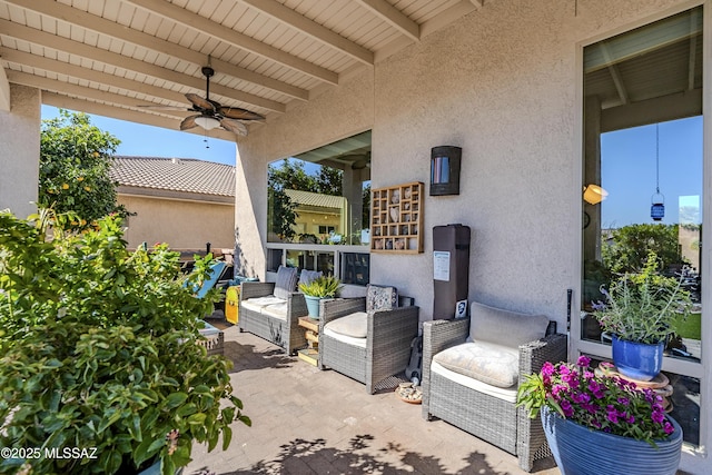 view of patio with ceiling fan and outdoor lounge area