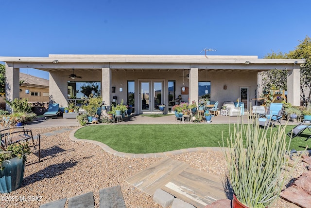 back of property featuring ceiling fan, french doors, a lawn, and a patio area