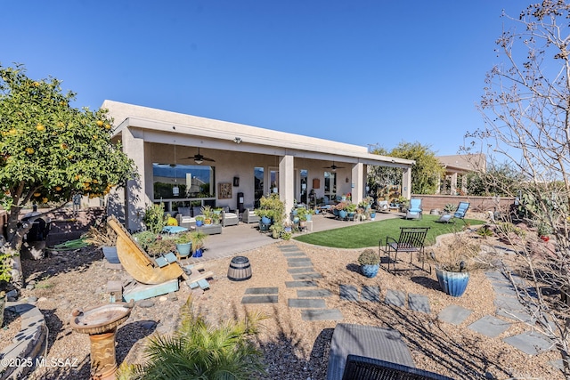 back of house featuring ceiling fan, a patio area, and outdoor lounge area