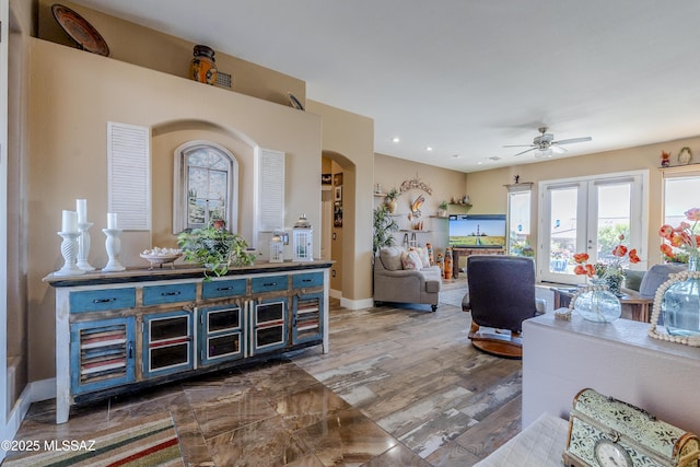 living room with ceiling fan and hardwood / wood-style flooring