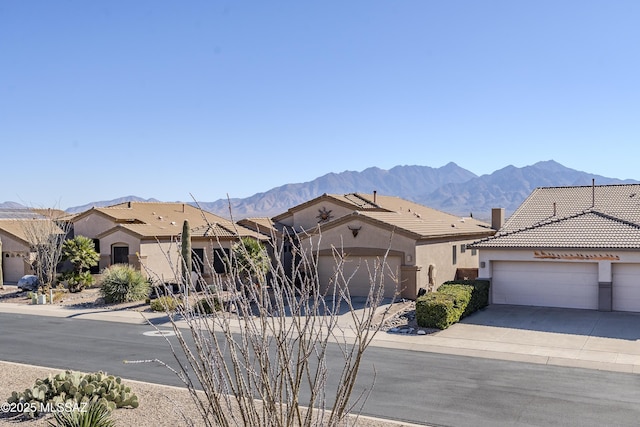 view of front of property featuring a garage and a mountain view