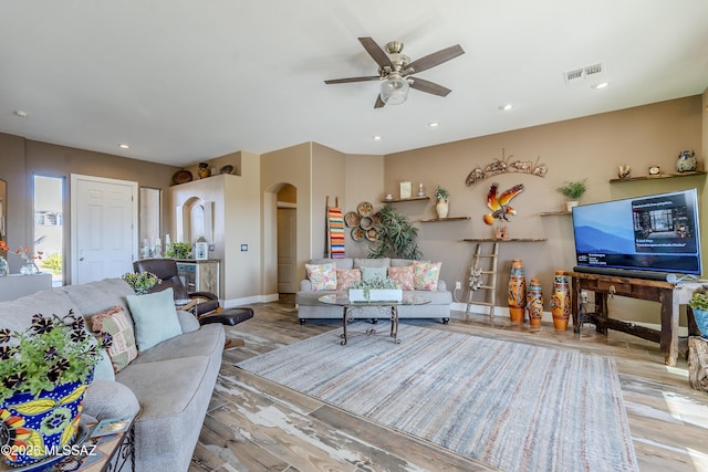 living room with light wood-type flooring and ceiling fan