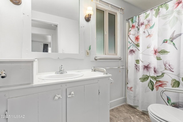 bathroom with vanity, toilet, and curtained shower