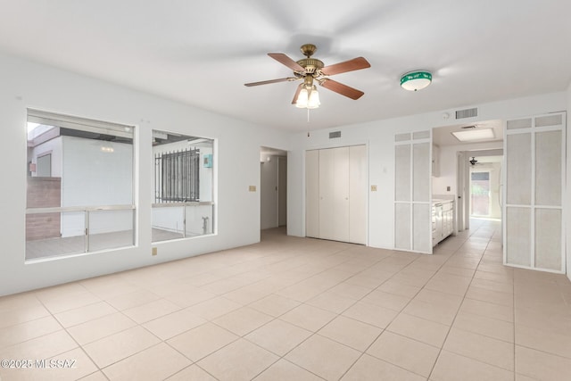 interior space featuring light tile patterned flooring and ceiling fan