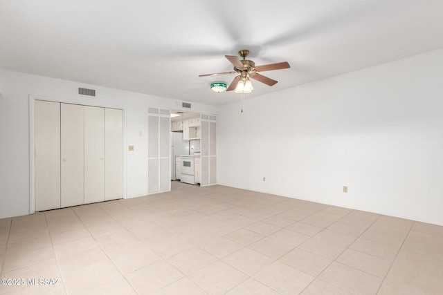 unfurnished bedroom with washer / dryer and ceiling fan