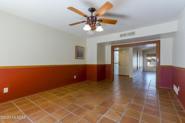 spare room with tile patterned flooring and ceiling fan