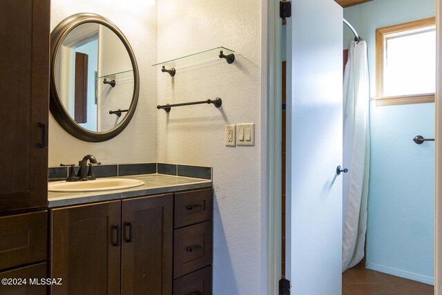 bathroom with tile patterned flooring, vanity, and a shower with shower curtain