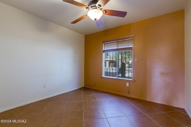 tiled empty room with ceiling fan