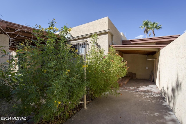 view of side of property with a carport