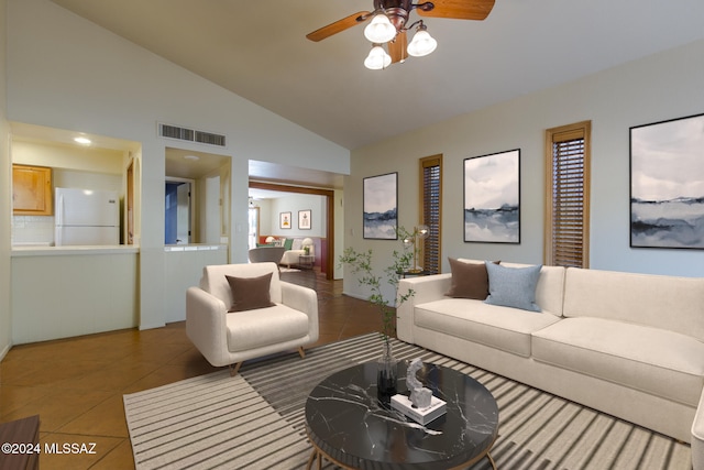 tiled living room featuring ceiling fan and high vaulted ceiling