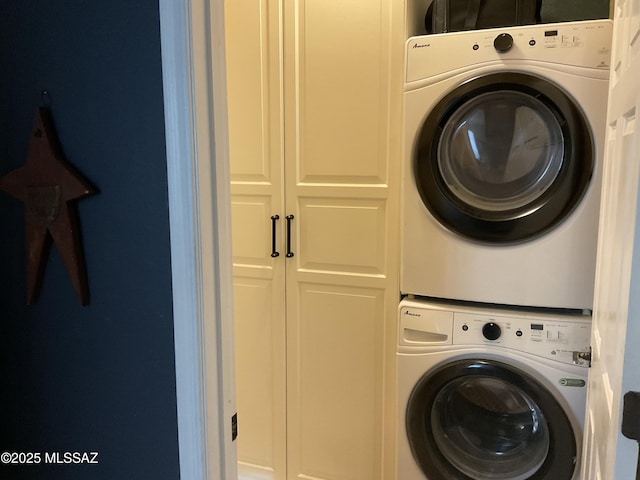 washroom with cabinets and stacked washing maching and dryer