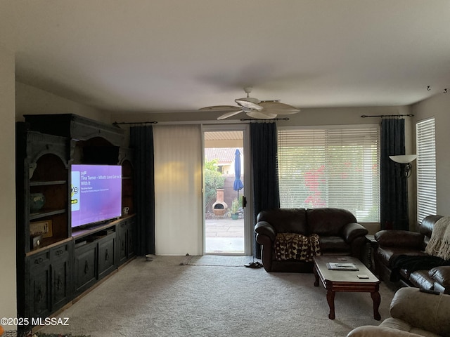 carpeted living room featuring ceiling fan and a wealth of natural light