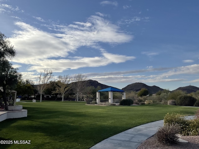 view of community with a lawn, a mountain view, and a gazebo