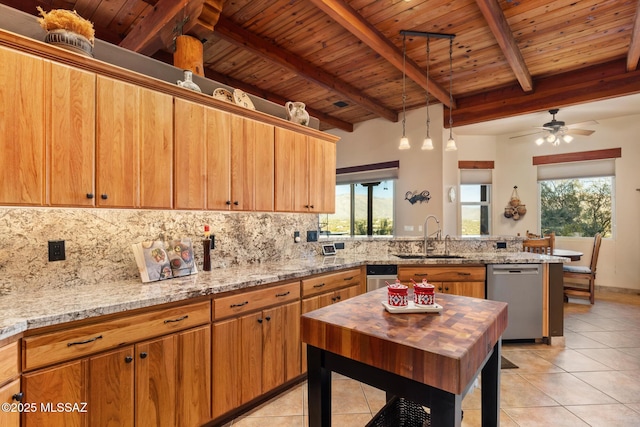 kitchen featuring beam ceiling, dishwasher, sink, light stone counters, and light tile patterned flooring