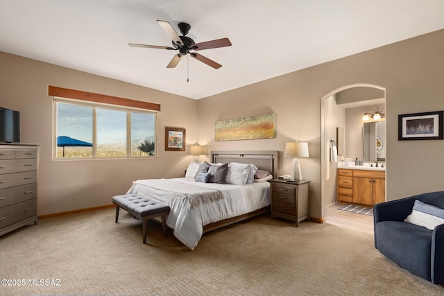 carpeted bedroom featuring ensuite bathroom and ceiling fan