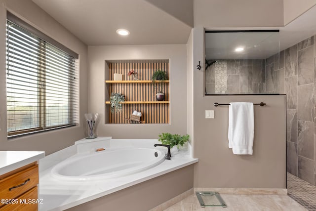 bathroom with tile patterned flooring, vanity, and independent shower and bath