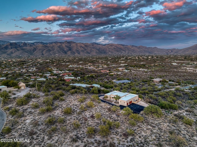 aerial view at dusk featuring a mountain view