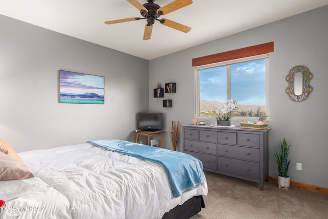 bedroom featuring ceiling fan and light carpet